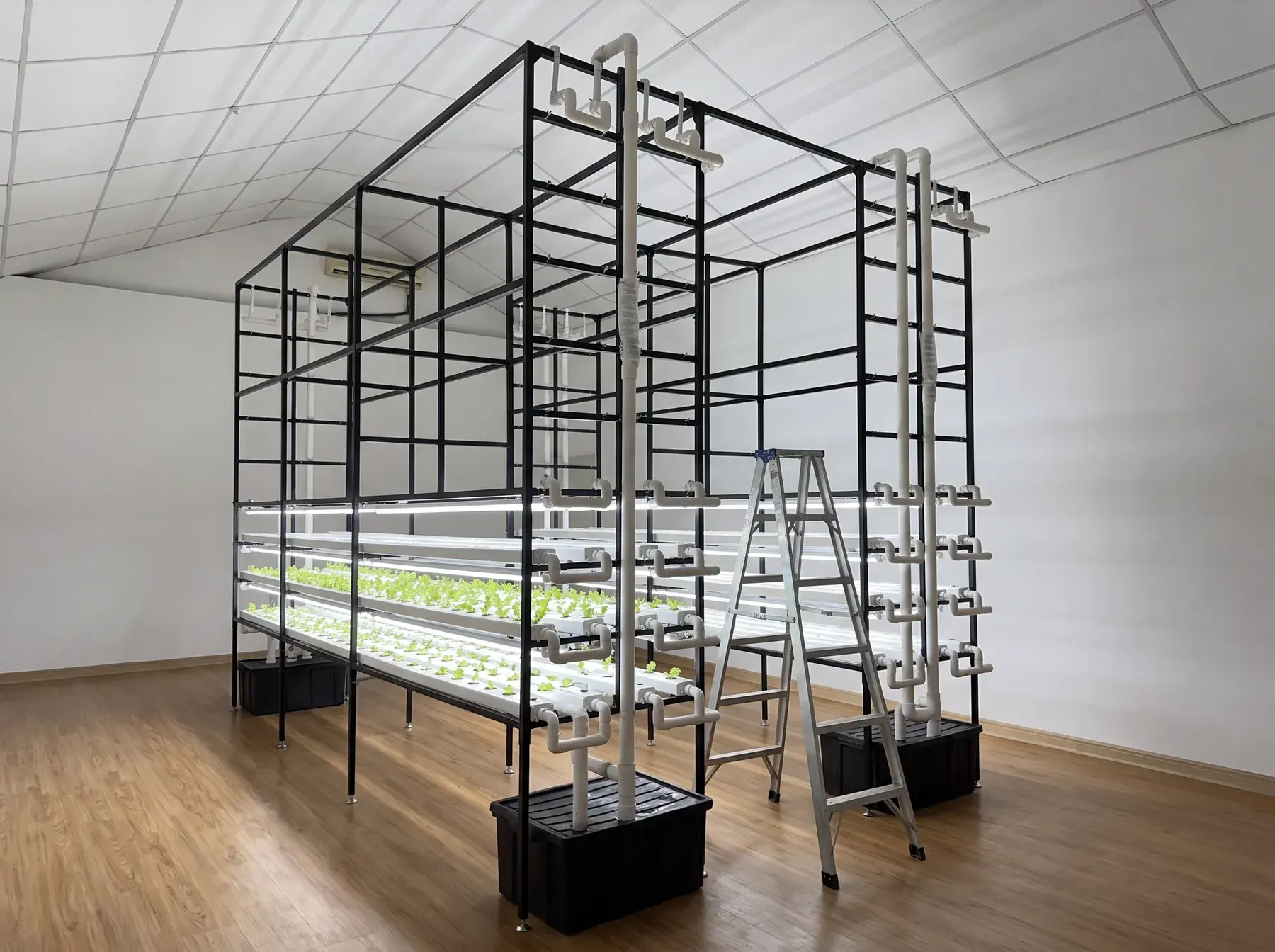 A racking system part-built, gutters and lights installed on black steel frames